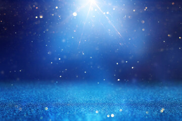 background of abstract glitter lights. silver, blue and gold. de focused
