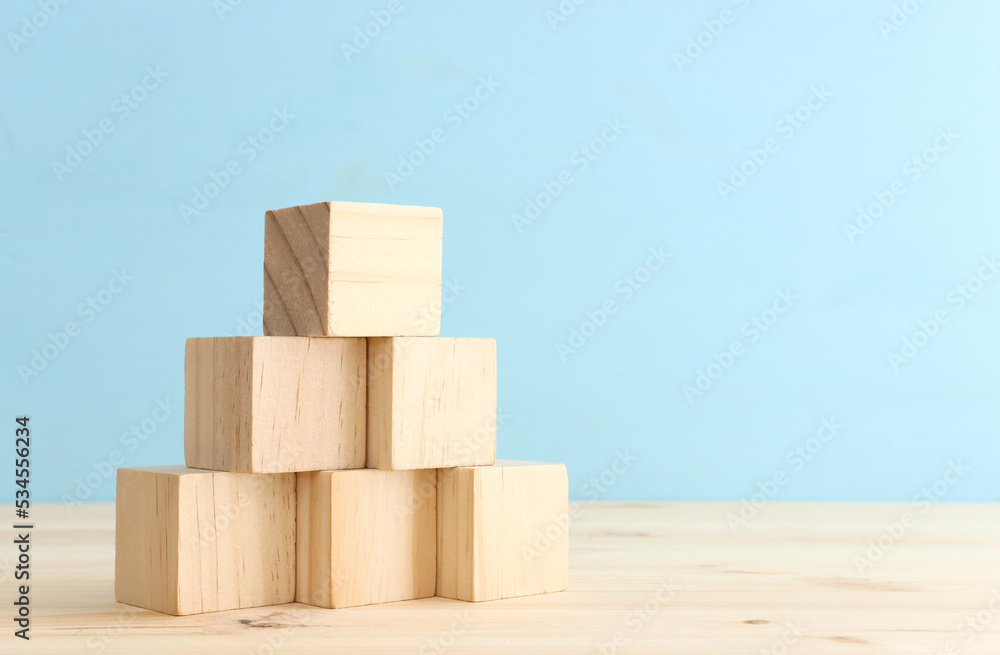 Stack of empty wooden cubes on table forming ladder Stack of empty wooden cubes on table forming ladder