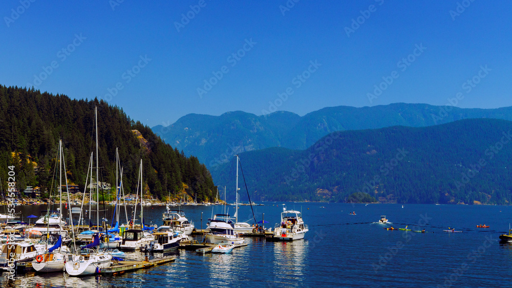 Watercraft, paddleboarders and kayakers off Deep Cove, BC, on a hazy summer day.