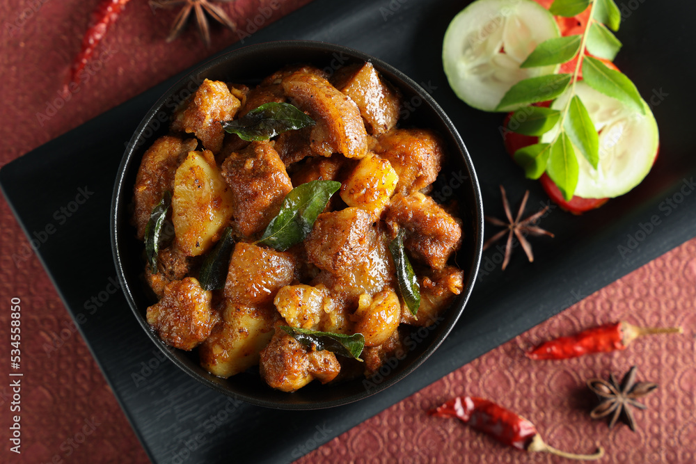 Spicy hot meat curry from Kerala India. Pork pig masala curry vindaloo