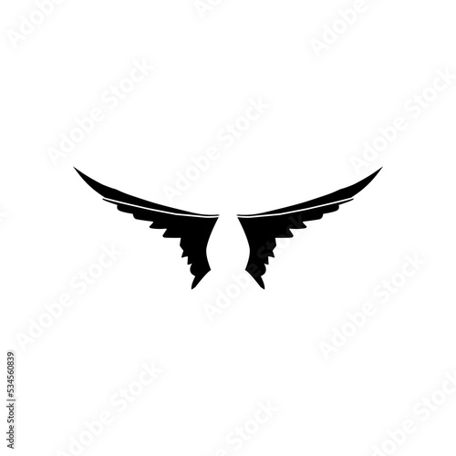 A pair of bird wings. Angel. Vector illustration for tattoo. Element for wood carving.