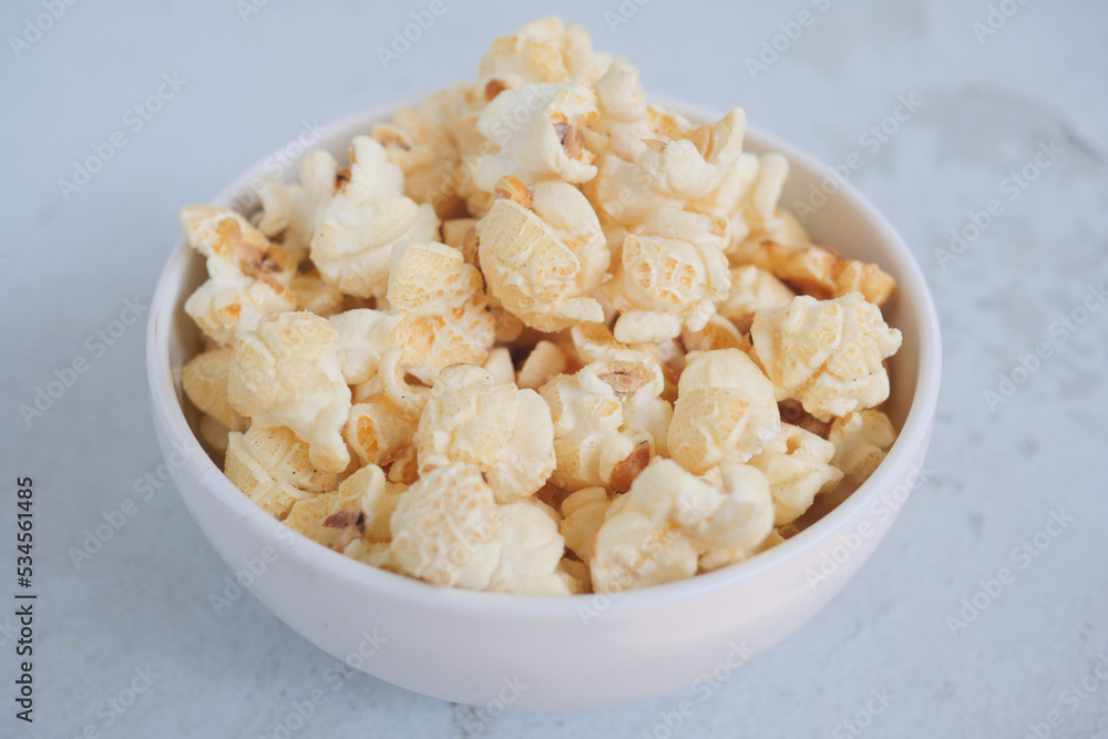  popcorn in a bowl on wooden desk