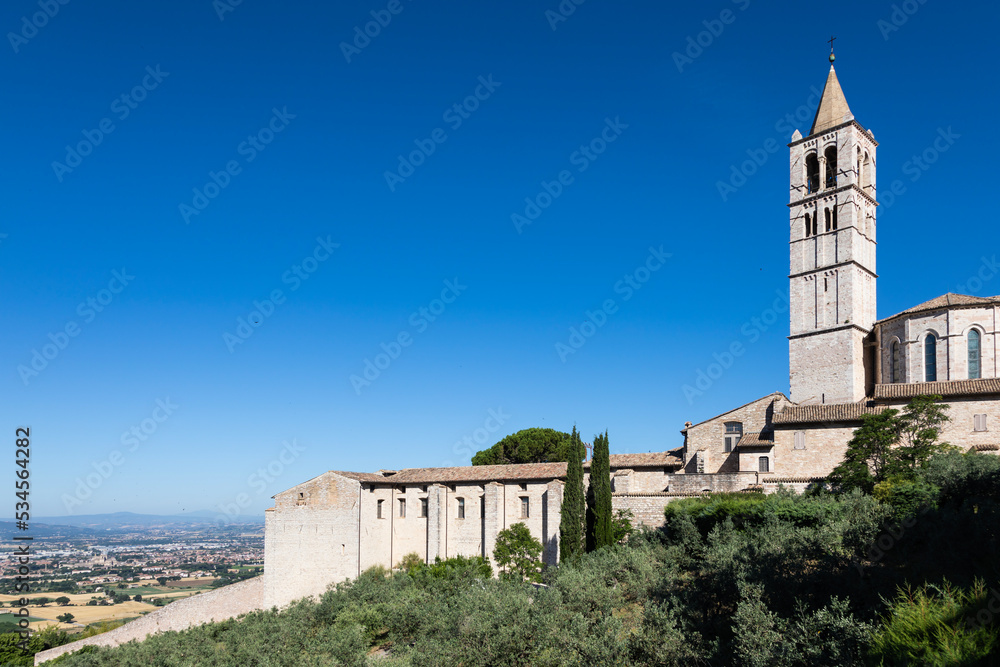 Church in Assisi village in Umbria region, Italy. The town is famous for the most important Italian Basilica dedicated to St. Francis - San Francesco. Church in Assisi village in Umbria region, Italy. The town is famous for the most important Italian Basilica dedicated to St. Francis - San Francesco.