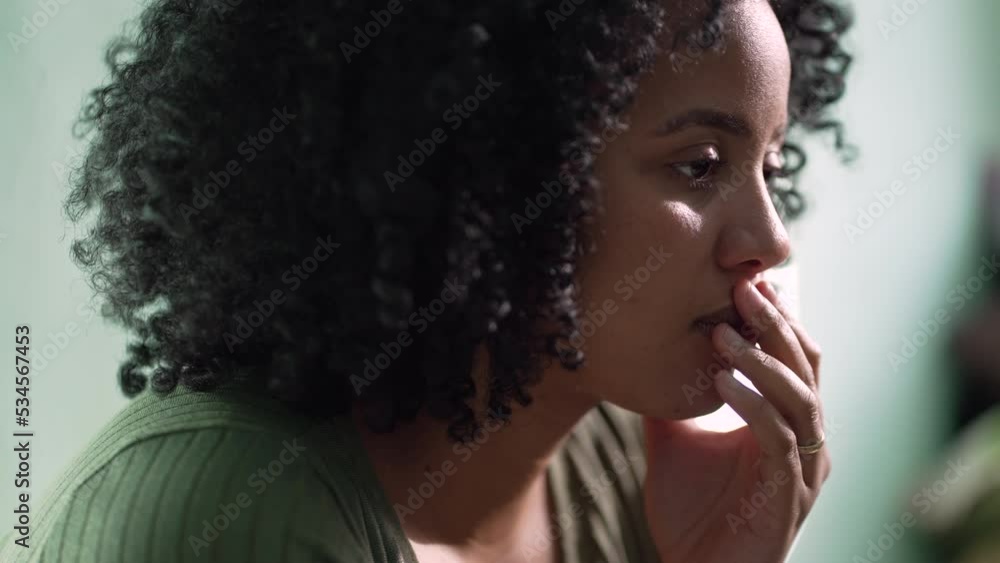 A pensive African American woman closeup face with contemplative emotion pondering solution A pensive African American woman closeup face with contemplative emotion pondering solution
