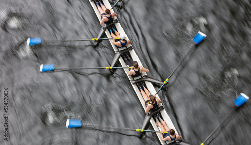 Overhead view of female crew racers rowing in an octuple racing shell, an eights team.