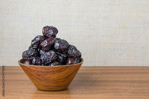 Delicious ajwa dates ( kurma nabi ), Much sought after during the month of Ramadan as a dish for breaking the fast, ramadhan kareem, empty space, copy space. photo