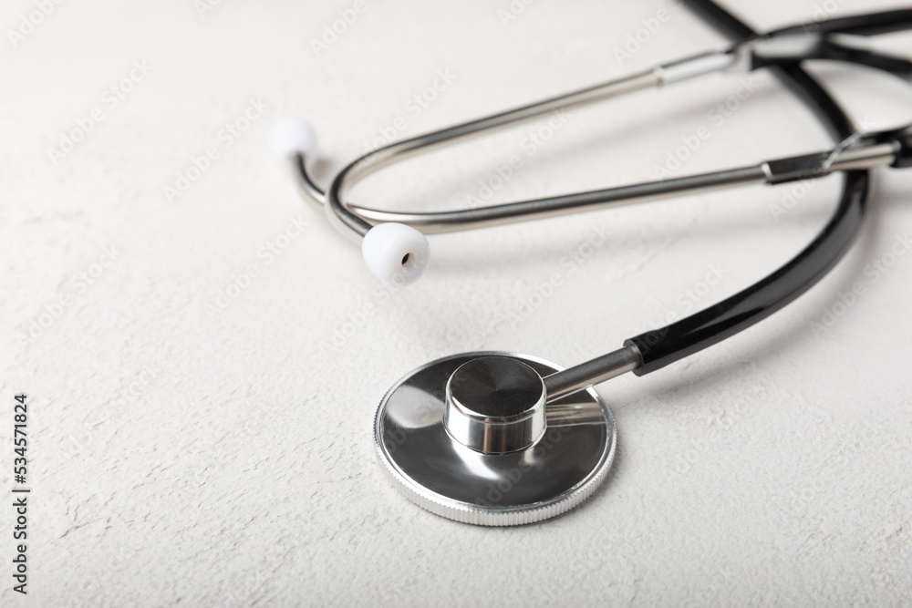 Black stethoscope on a gray background. Health care and medicine concept.health and doctor symbols.Close-up. Place to copy. Black stethoscope on a gray background. Health care and medicine concept.health and doctor symbols.Close-up. Place to copy.