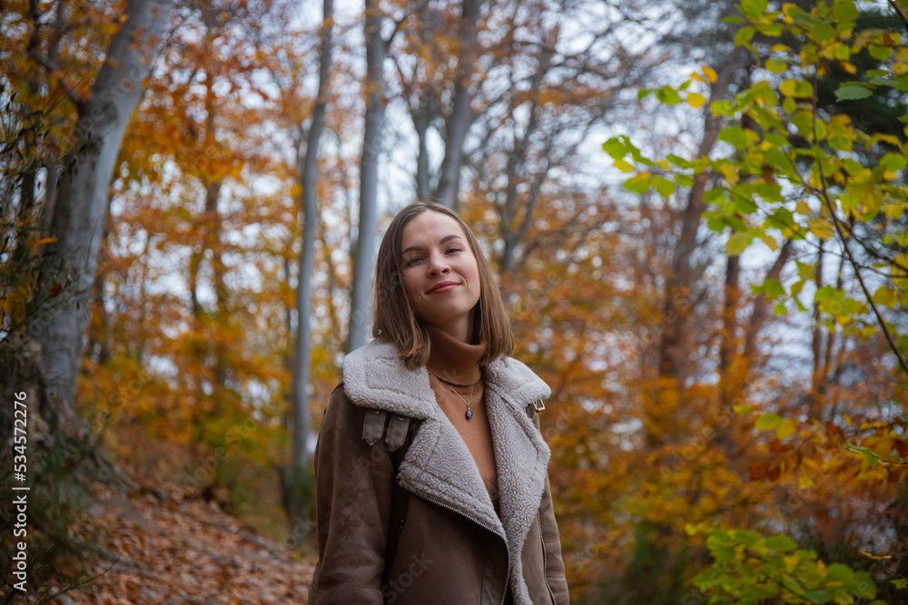 A portrait of a sweet girl with short hair enjoying the autumn weather; playing with colourful autumn leaves; having fun in autumn leaves A portrait of a sweet girl with short hair enjoying the autumn weather; playing with colourful autumn leaves; having fun in autumn leaves