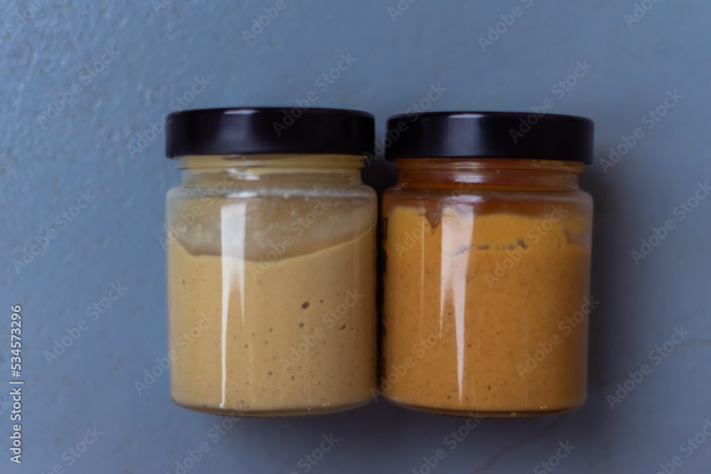Peanut butter in а glass jar. Eco healthy vegan food concept Peanut butter in а glass jar. Eco healthy vegan food concept