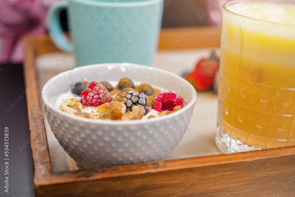 Cute and healthy breakfast with coffee, orange juice and a bowl of yogurt and fruit in a brunch style Cute and healthy breakfast with coffee, orange juice and a bowl of yogurt and fruit in a brunch style