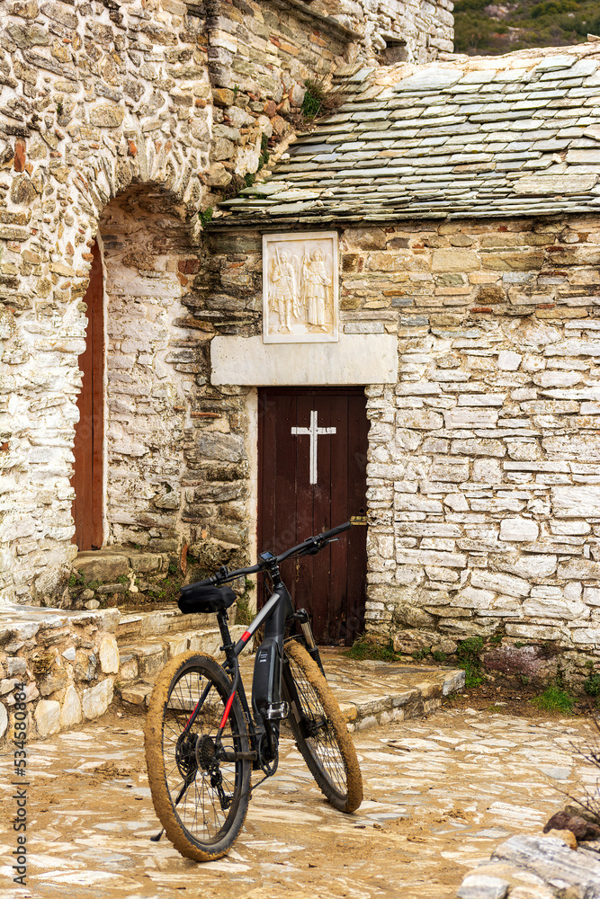 An e-bike at the Orthodox monastery Saints Asomatos in Penteli, a mountain to the north of Athens in Greece An e-bike at the Orthodox monastery Saints Asomatos in Penteli, a mountain to the north of Athens in Greece