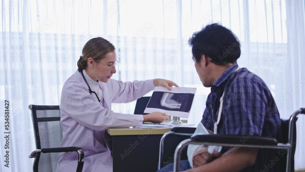 Caucasian Woman doctor talking consultant describe treatment of broken arm bone to patient man in hospital. service with modern medical technology. explain care. Concept medical care orthopedic Caucasian Woman doctor talking consultant describe treatment of broken arm bone to patient man in hospital. service with modern medical technology. explain care. Concept medical care orthopedic