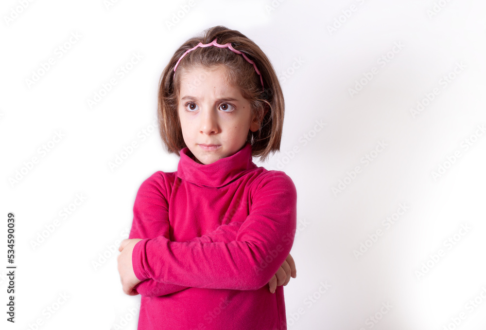 Cute upset little girl standing isolated over white background Cute upset little girl standing isolated over white background