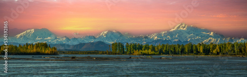 A panorama image of the Alaska Range at sunset with Mt McKinley (Denali), Mt Hunter, Mt Foraker, and the Susitna River,  photo