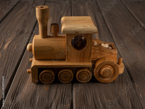 Wooden train toy on a dark background