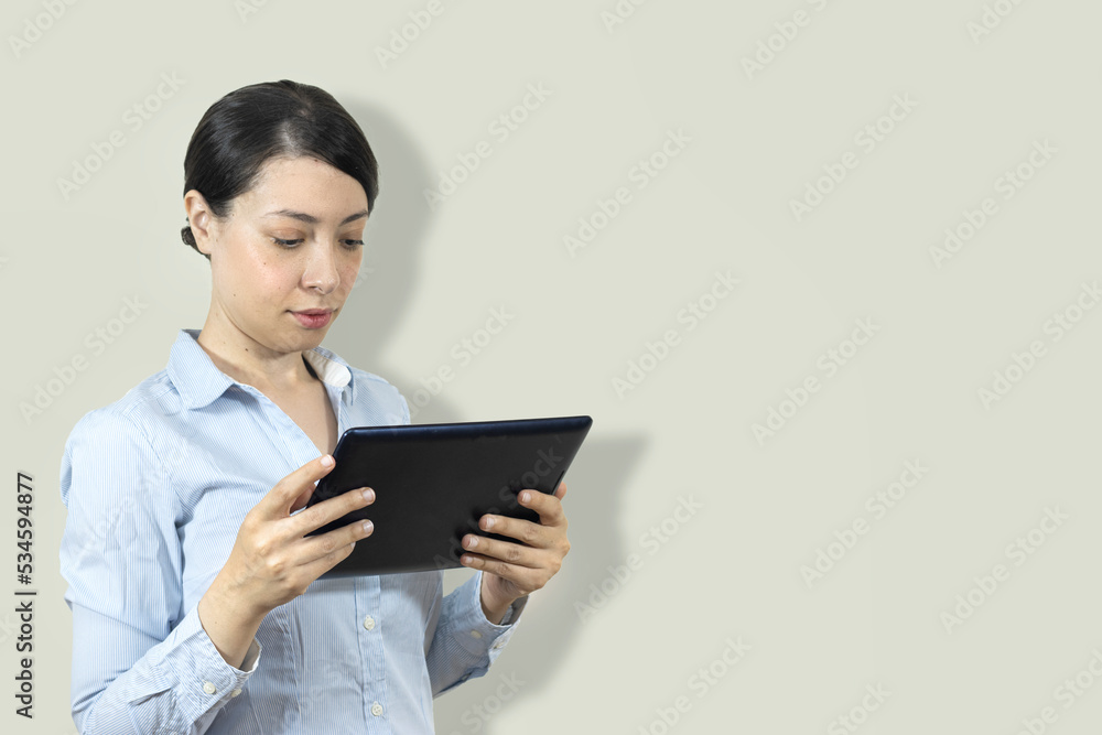 Elegant businesswoman standing in office with digital tablet Elegant businesswoman standing in office with digital tablet