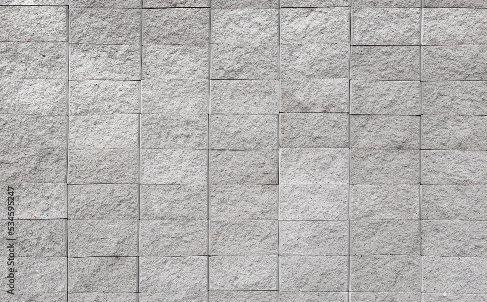 Grey brick wall background close up. Gray stone tile block background
