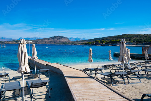 Beach with umbrellas and deck chairs in Ksamil in Albania