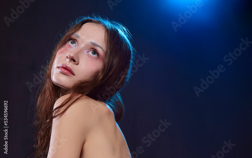 portrait of a seductive woman with perfect evening makeup looking into the camera