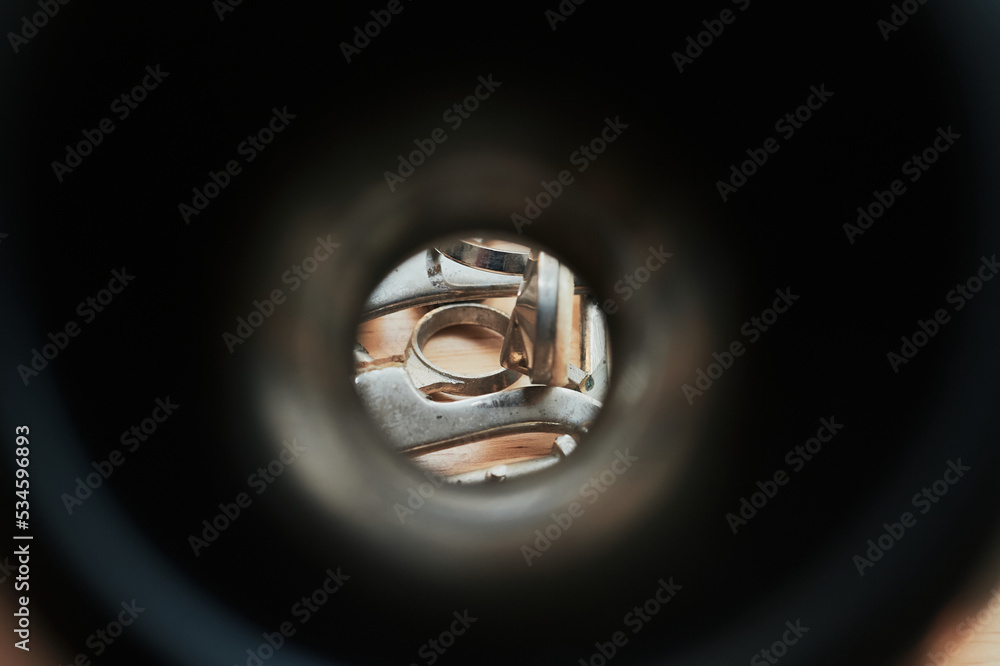 Various old clarinet keys and pads are seen through the aperture of a clarinet bell Various old clarinet keys and pads are seen through the aperture of a clarinet bell