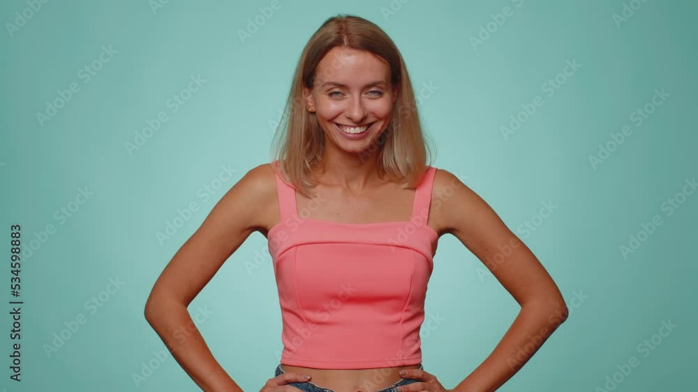 Lovely cheerful woman in crop top greatly approves your suggestion, shaking head approvely, satisfied with good quality work, like proposal. Young adult girl isolated on blue studio wall background Lovely cheerful woman in crop top greatly approves your suggestion, shaking head approvely, satisfied with good quality work, like proposal. Young adult girl isolated on blue studio wall background