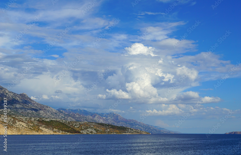 Beautiful cloudscape above deep blue sea and land with nature in clean environment Beautiful cloudscape above deep blue sea and land with nature in clean environment