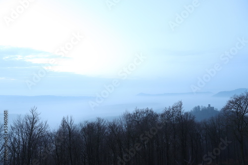 Sunrise in autumn with fog and clouds. Viewpoint in the Palatinate Forest. Morning mood in nature. Landscape shot on a mountain © jan