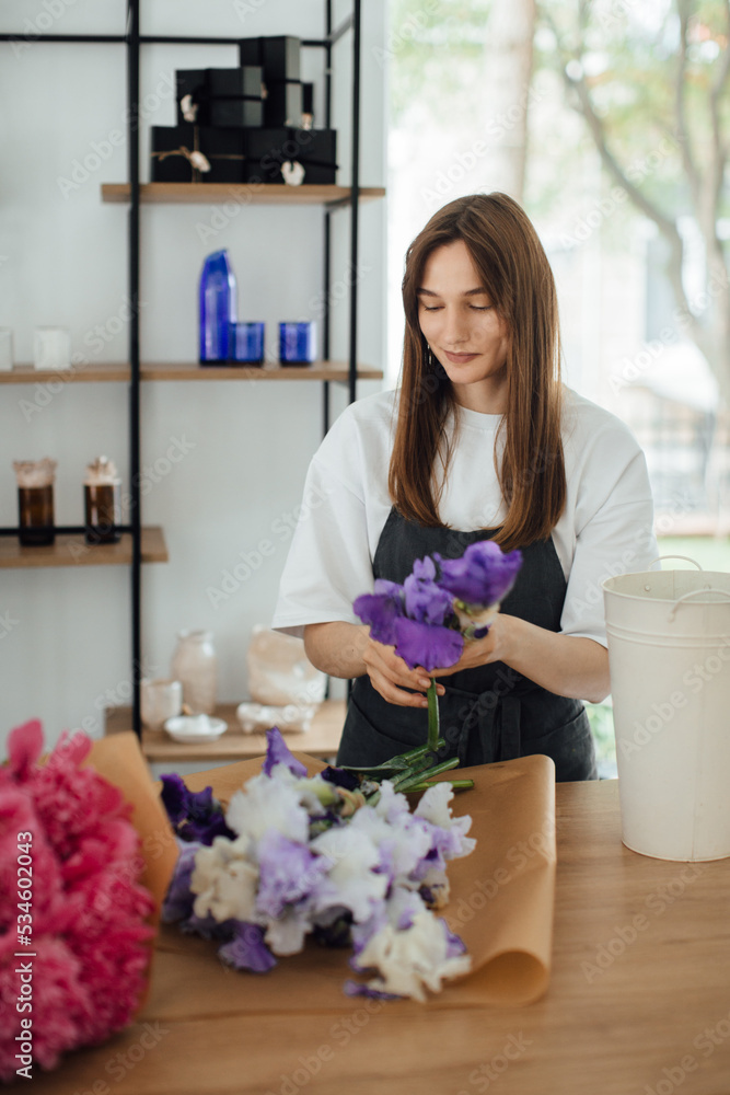 Owner working at flower shop - stock photo.