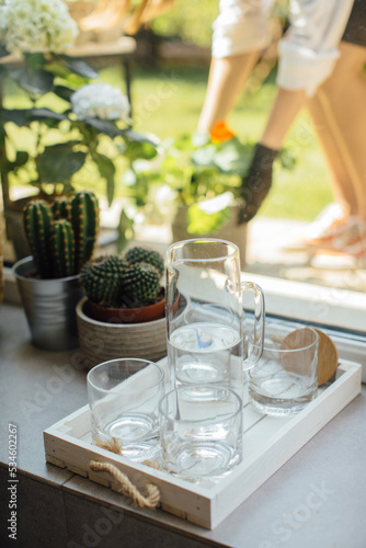 Glasses of water on the windowsill, still life. © dsheremeta