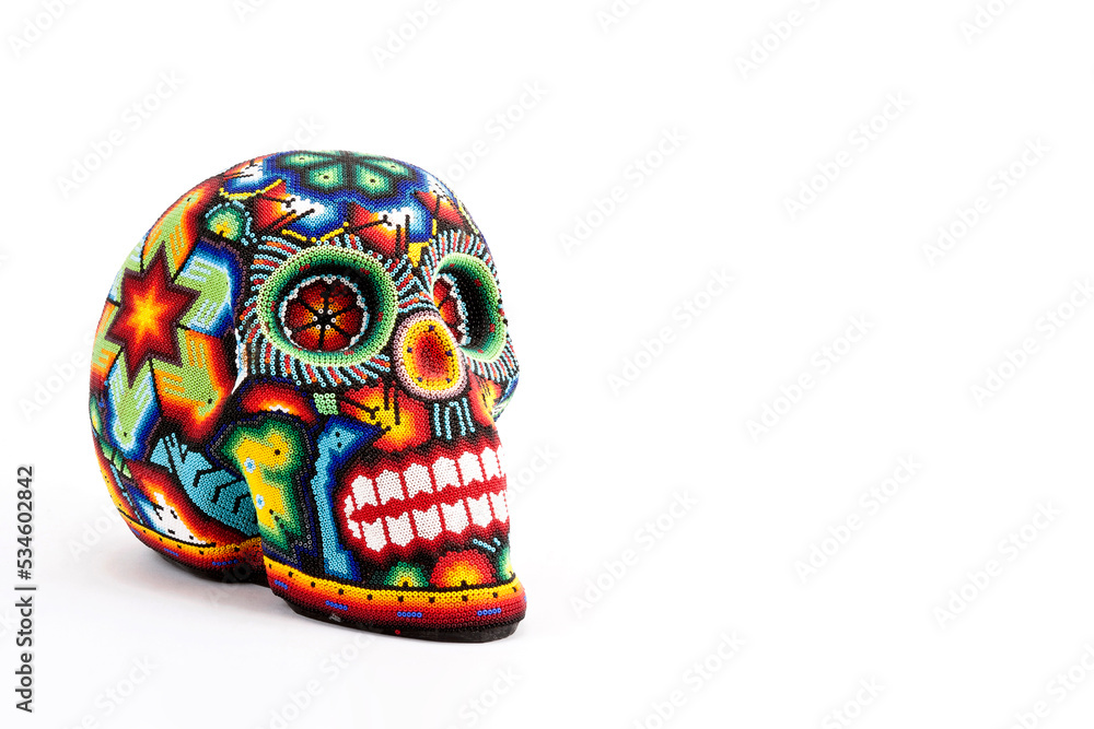 Colorful skulls, Mexican handicrafts. Day of the Dead, handmade Huichol figure of chaquira, Mexico Colorful skulls, Mexican handicrafts. Day of the Dead, handmade Huichol figure of chaquira, Mexico