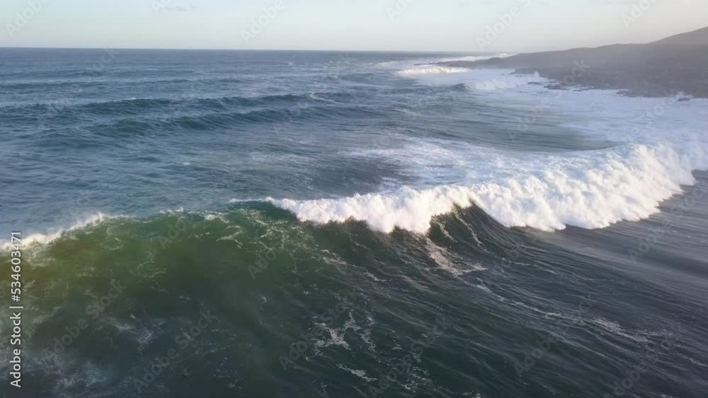 Aerial of waves breaking onto a coastline Aerial of waves breaking onto a coastline