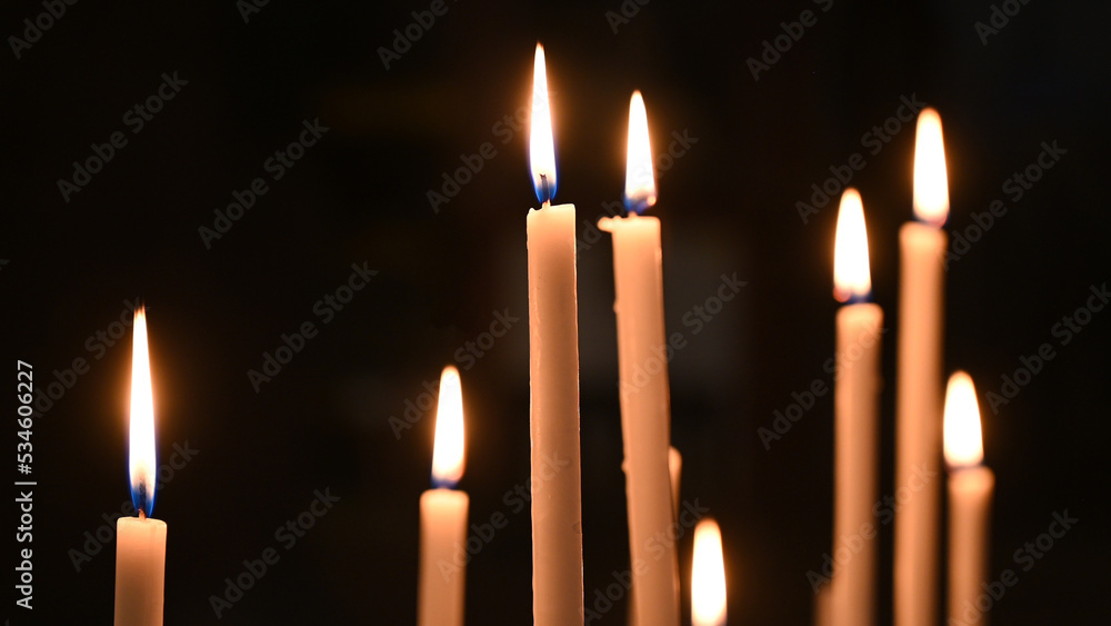 Candles burning in cathedral. Votive candles glows in the church