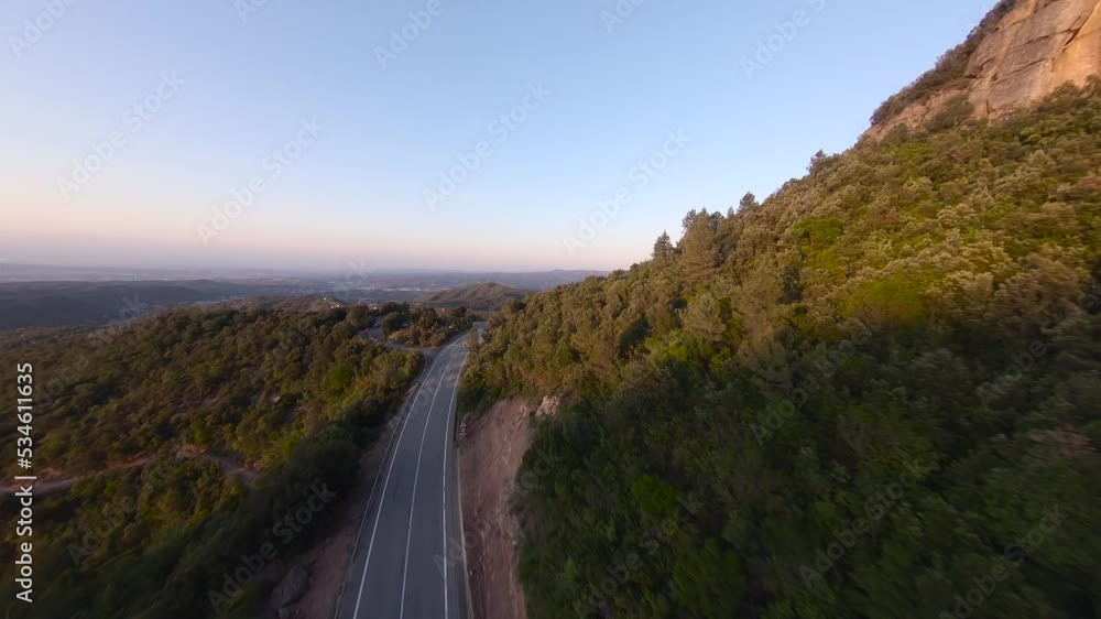 FPV drone flying over trees during sunset. Beautiful landscape with mountains in the background. Montserrat mountains in Spain. Fpv drone. FPV drone flying over trees during sunset. Beautiful landscape with mountains in the background. Montserrat mountains in Spain. Fpv drone.