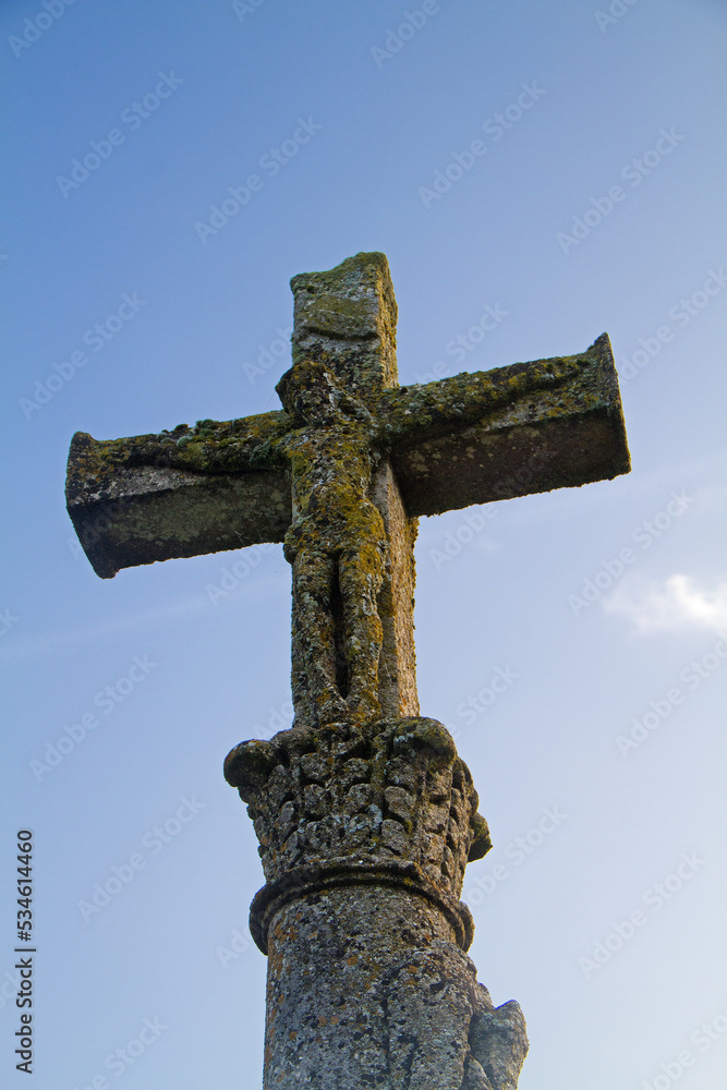 18th century stone crucifix depicting the crucified Jesus Christ