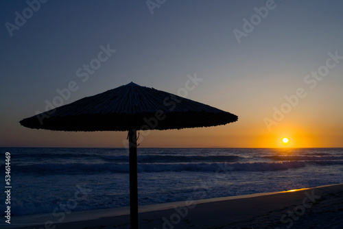 An umbrella silhouette during sunset in Vrahos beach.