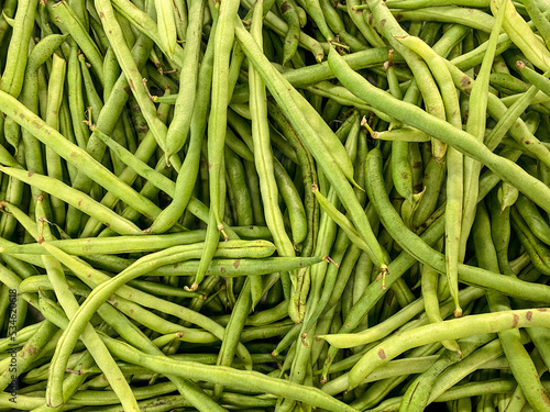 Organic Fresh raw string bean or french beans or buncis in Bahasa, as background, top view photo