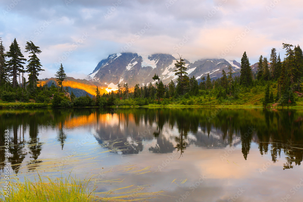 Mount Shuksan at sunset with reflection view from Picture Lake, Deming Washington. Picture Lake is the centerpiece of a strikingly beautiful landscape in the Heather Meadows area
