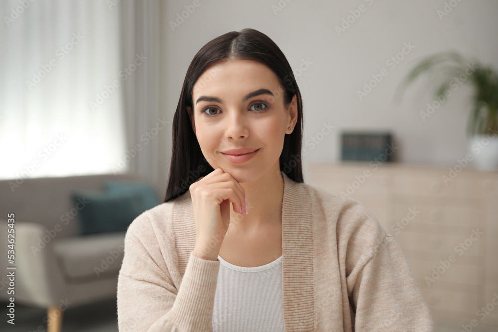 Beautiful young woman conducting webinar in room, camera view Beautiful young woman conducting webinar in room, camera view