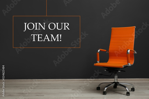 Canvas Print Join our team! Orange office chair near black wall indoors