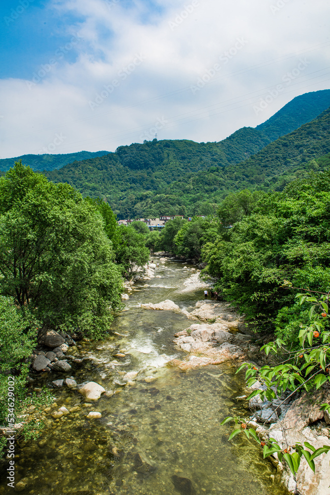 Fototapeta premium Wild stream brook through through the rocks of a mountain