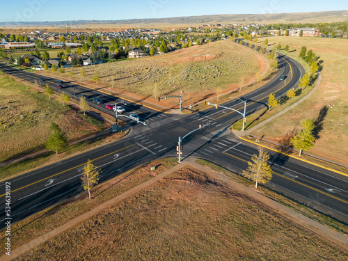Car traffic intersection with stop lights roads in rural Fall Wyoming from 4k Aerial drone dji mini 3 pro