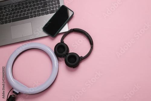 Led ring lamp with laptop, smartphone and headphones on a gray background. Gear for blogging and vlogging. Top view. Flat lay. Copy space