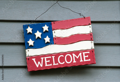  decorative wooden welcome sign on a home, looking like n American flag