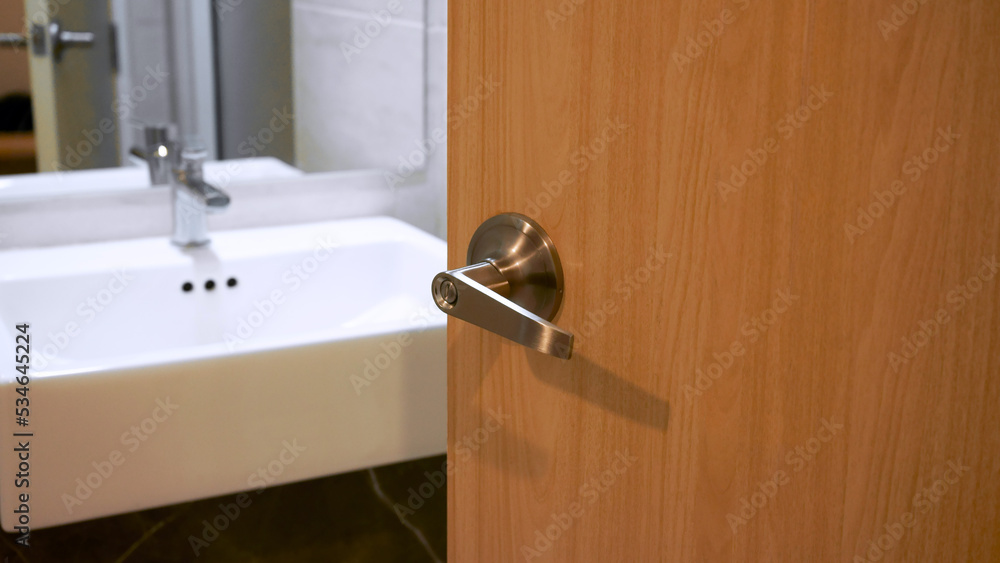 Bathroom door handles,door with stainless knob door half open in front