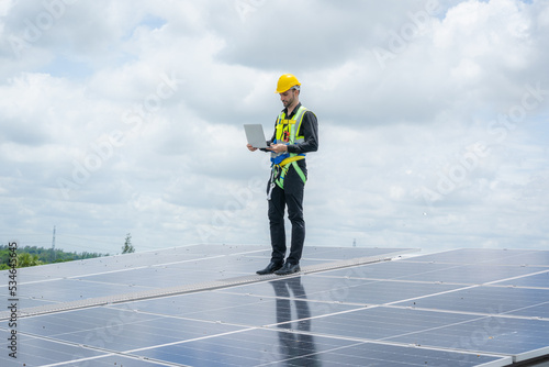 Engineer or worker installing a solar cell on the roof in warehouse factory,Eco technology for electric power.