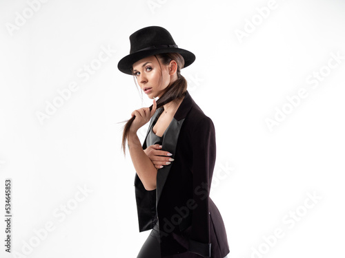 Stylish young woman in a black hat and jacket, close-up