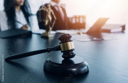 justice and law concept.Male judge in a courtroom on wooden table and Counselor or Male lawyer working in office. Legal law, advice and justice concept.