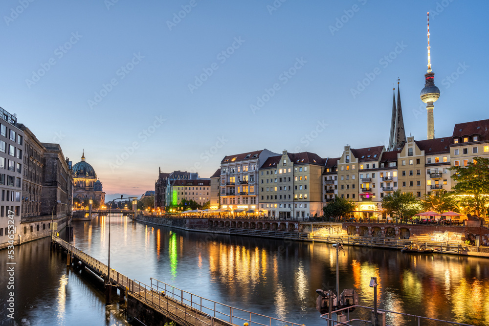 Fototapeta premium The Nikolaiviertel, the river Spree and the Cathedral in Berlin after sunset