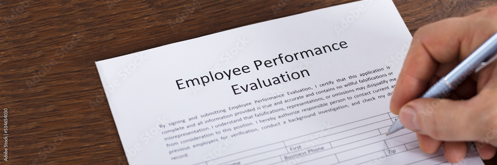Person Filling A Performance Evaluation Form Person Filling A Performance Evaluation Form