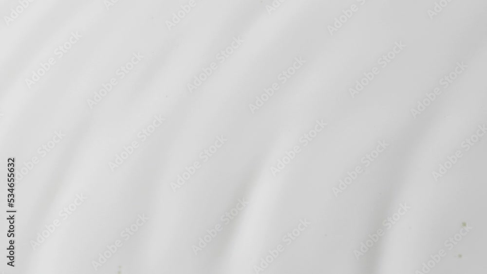 Slow motion white liquid cream ripples, close-up fresh milk drink splash texture Slow motion white liquid cream ripples, close-up fresh milk drink splash texture